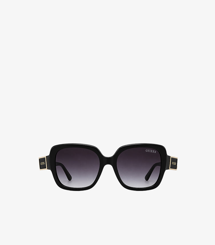Angled view of Guess black square sunglasses featuring wide arms and gold-tone temple branding