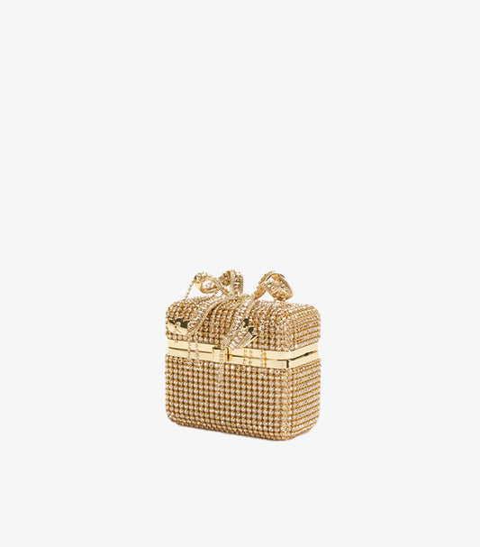 Angled view of Self-Portrait crystal embellished gold clutch bag