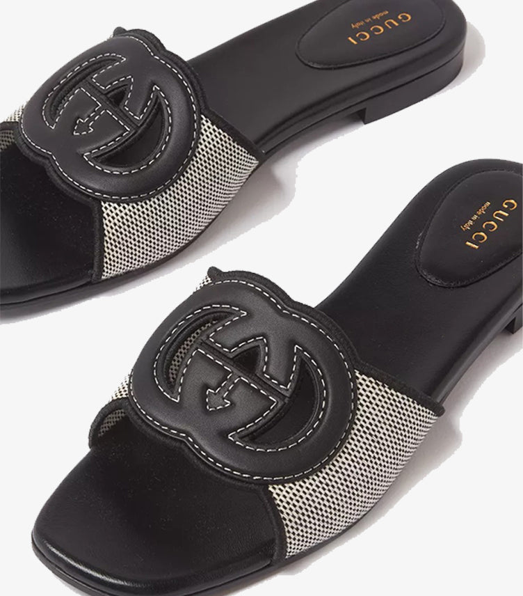 Gucci Interlocking G flat slides top view showing GG leather logo and GUCCI Made in Italy insole