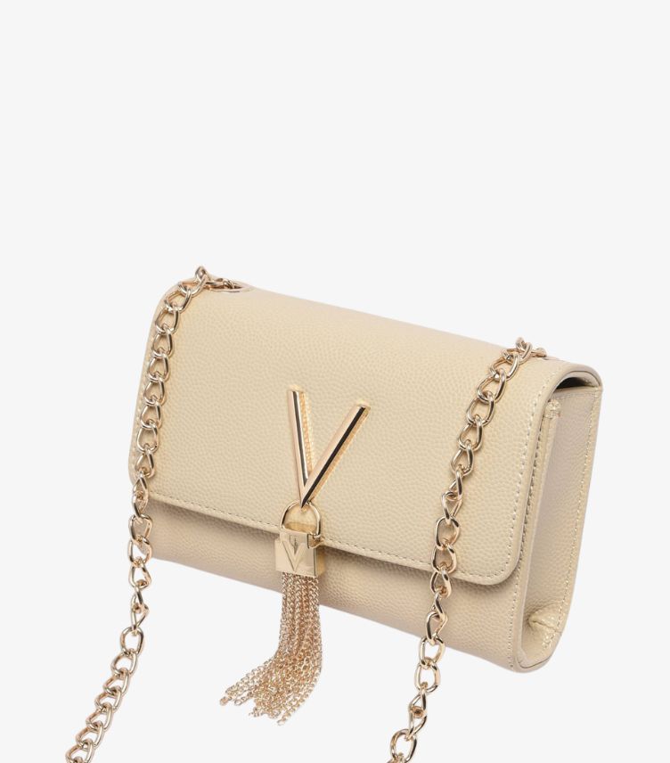 Angled close-up of Valentino by Mario Valentino ivory crossbody bag with gold V-logo clasp, tassel and chain strap
