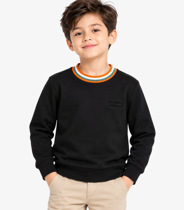 Boy wearing a Marks & Spencer black long-sleeve sweatshirt with an orange, white and green striped crew neckline