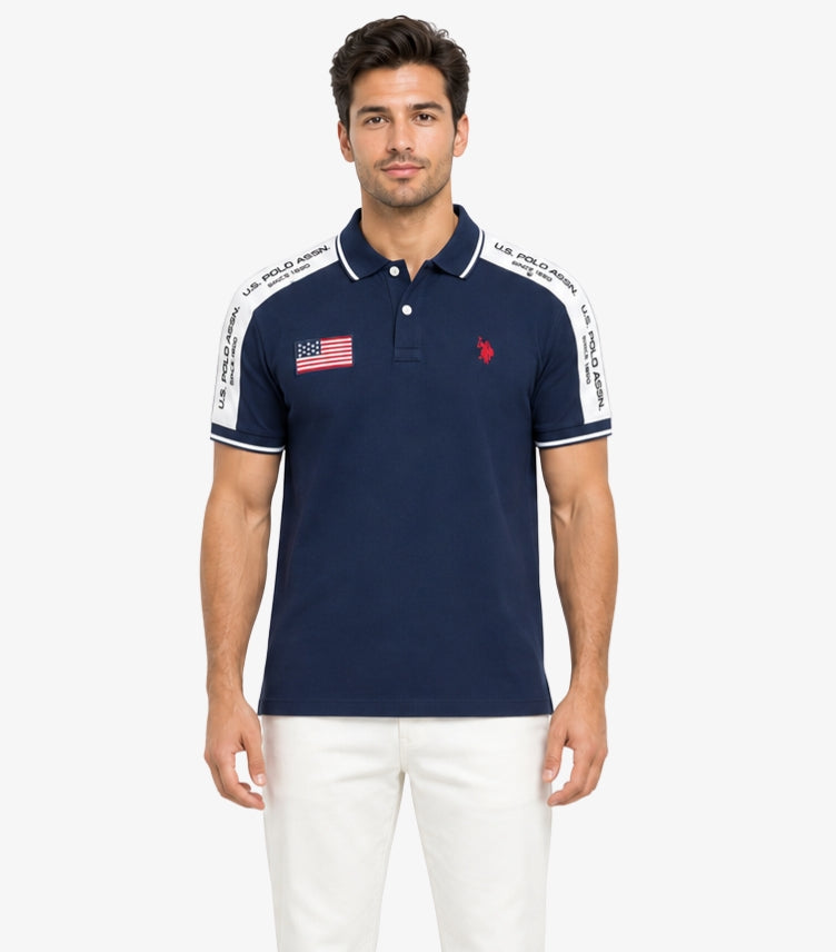 U.S. Polo Assn. men's navy short sleeve cotton polo shirt featuring embroidered logo, American flag patch, and branded contrast shoulder tape.