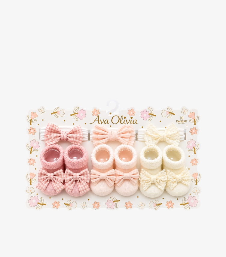Ava Olivia baby girls 6-piece bow headbands and booties gift set featuring three decorative bow headbands and three pairs of knitted baby booties on a floral display card.