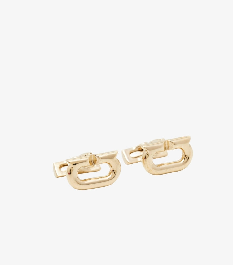 Angled view of Ferragamo gold-tone Gancini logo cufflinks showing the swivel-bar fastenings