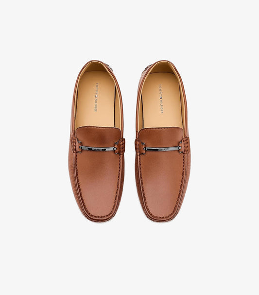 Top view of Tommy Hilfiger men’s brown leather driving loafers with branded metal bars and moccasin stitching