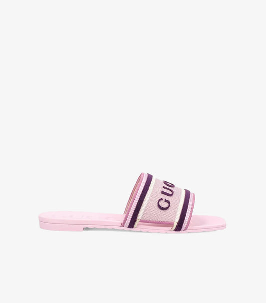 Side view of Gucci women’s pink slip-on sandal featuring purple and white stripe details