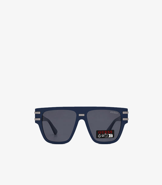 GUESS navy flat-top square sunglasses front view showing smoke grey lenses silver bar hardware and GUESS branding on lens
