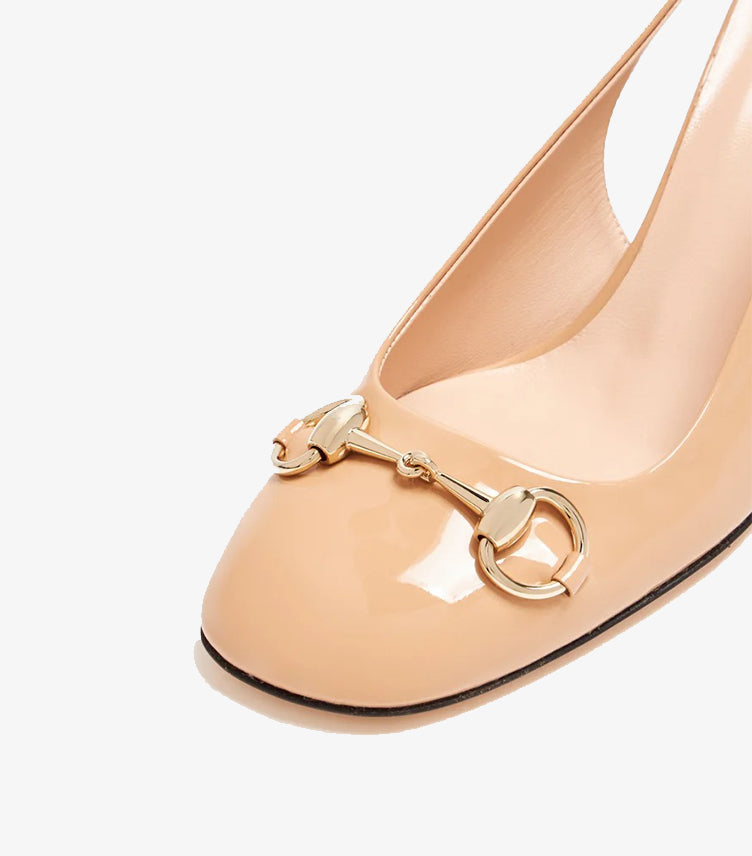 Close-up of Gucci Horsebit hardware on patent leather pump