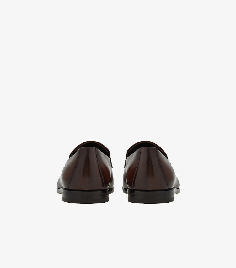 Ferragamo brown burnished leather Gancini Bit loafers back view showing heel construction and gradient finish