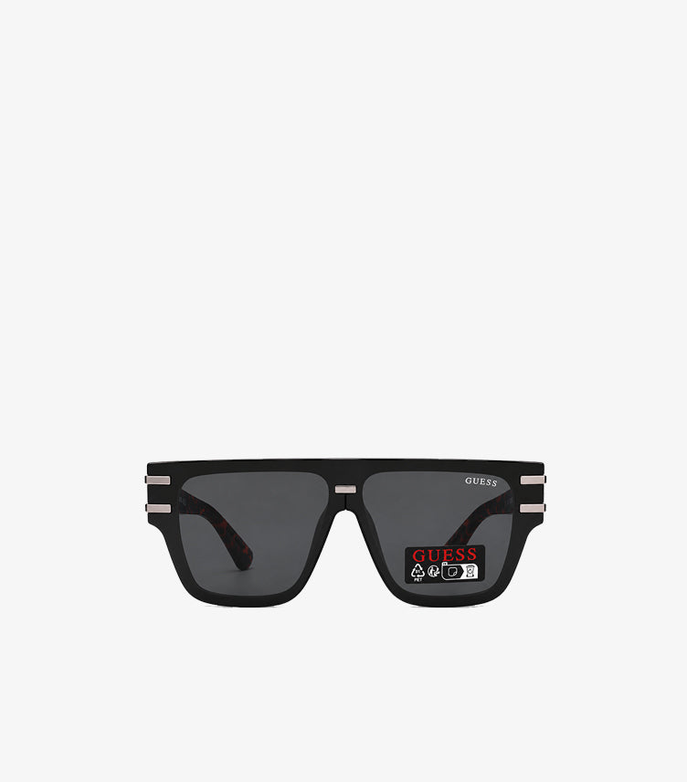 GUESS men's black square flat-top sunglasses front view showing smoke grey lenses silver hardware and GUESS branding on lens