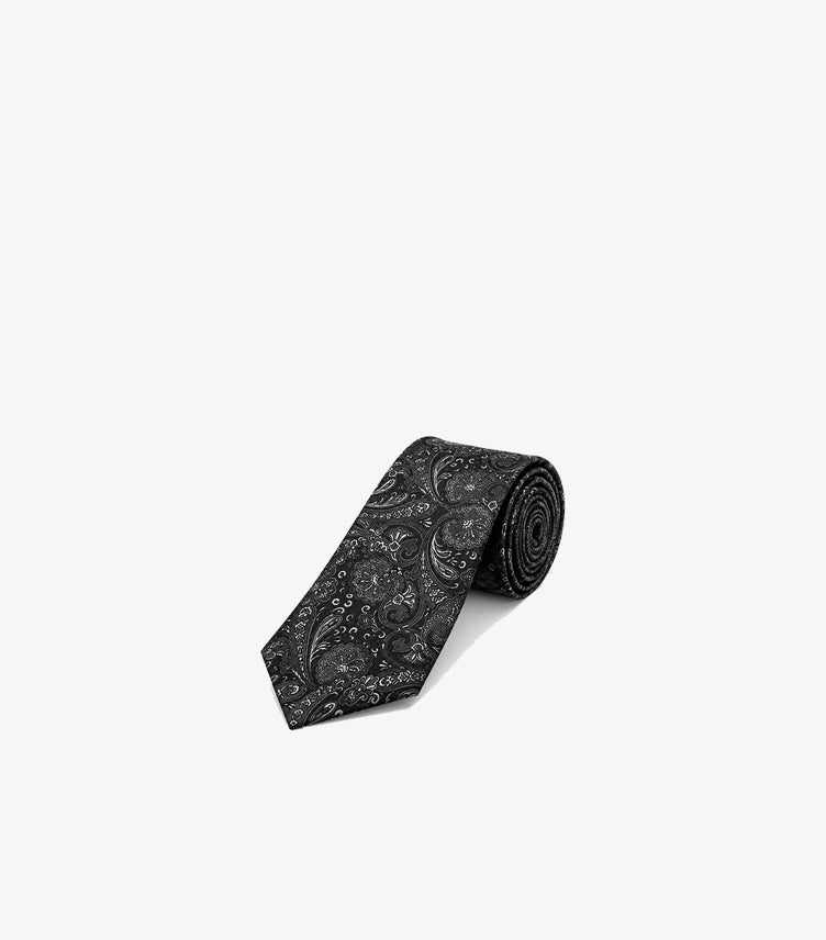 Rolled Tommy Hilfiger men’s formal necktie featuring an intricate all-over paisley pattern and classic pointed blade