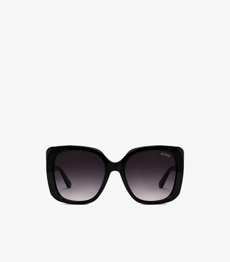 Guess women's oversized square sunglasses with glossy frame and gradient UV protection lenses, front view.
