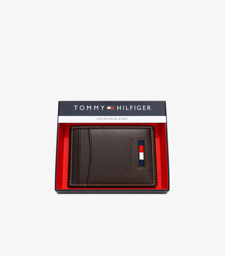 Tommy Hilfiger brown leather bifold card holder with flag logo displayed in branded gift box