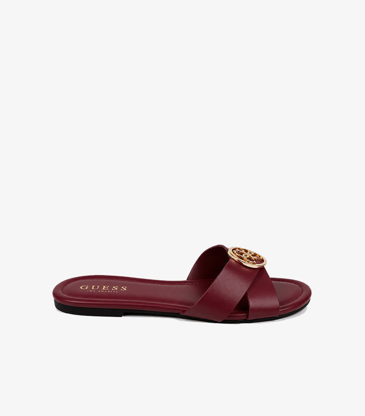 GUESS Los Angeles burgundy cross-strap flat slide sandal side profile showing gold script medallion and square toe