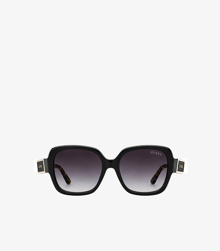 Front view of Guess black square sunglasses featuring dark gradient lenses and gold-tone temple logos