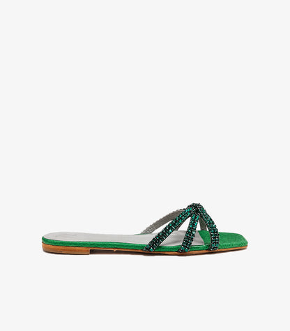 Side view of GINA emerald green crystal-embellished flat sandals with crossover straps