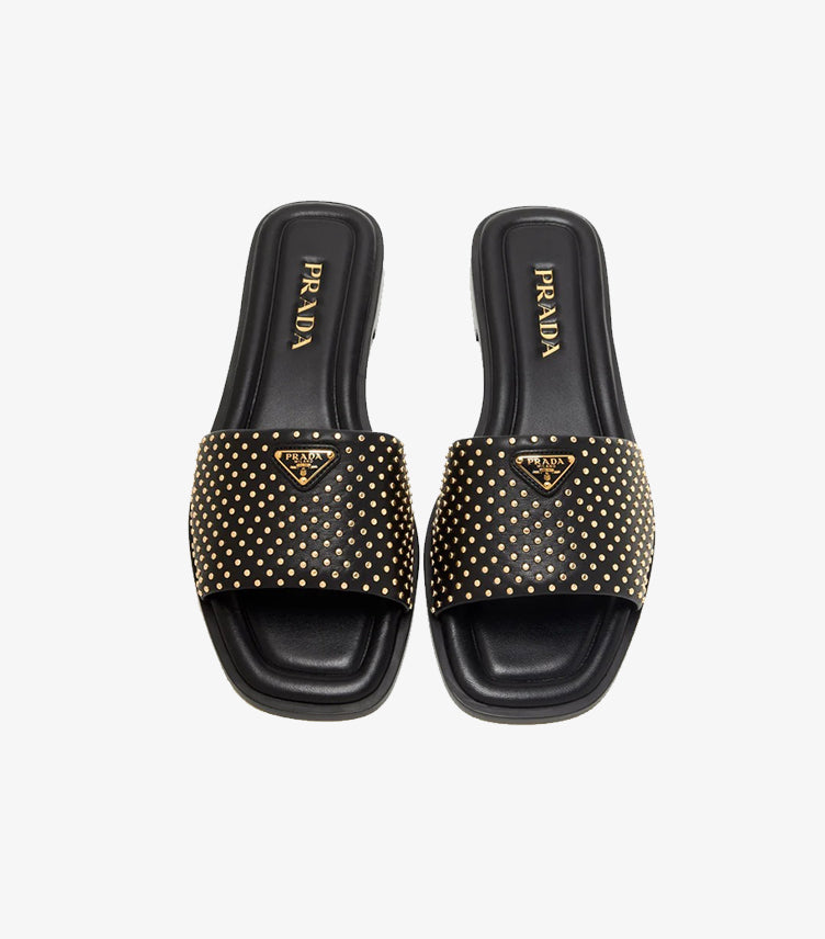 Prada black studded leather flat slides top view pair showing gold micro-studs triangle logo and PRADA branded footbed