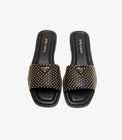 Prada black studded leather flat slides top view pair showing gold micro-studs triangle logo and PRADA branded footbed