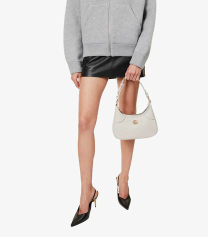 Model wearing Gucci Aphrodite Small white leather shoulder bag crossbody
