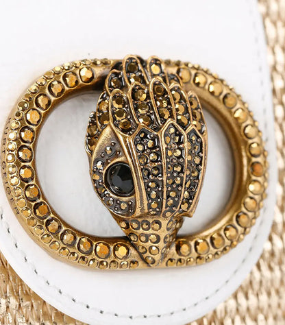 Close-up of Kurt Geiger Micro Chelsea Hobo bag showing its crystal-embellished antique brass eagle head