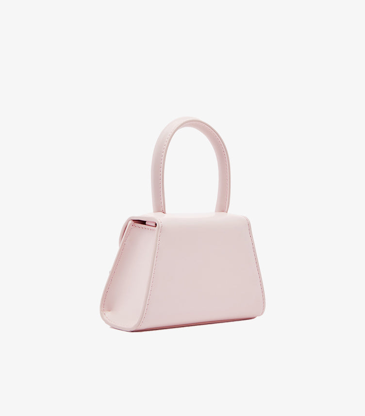 Self-Portrait pink structured mini trapeze bag side profile view showing top handle and clean silhouette