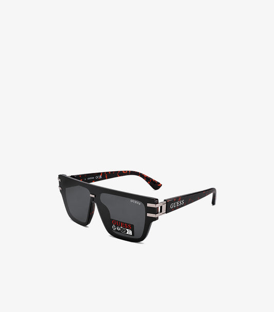 GUESS black flat-top square sunglasses angled view showing tortoiseshell red-brown temple interior silver hardware and GUESS temple branding