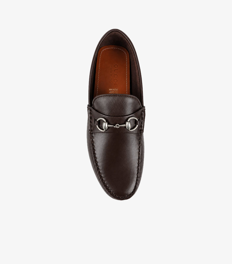 Top-down view of Gucci Horsebit driving loafer showing silver hardware and GUCCI Made in Italy tan leather insole