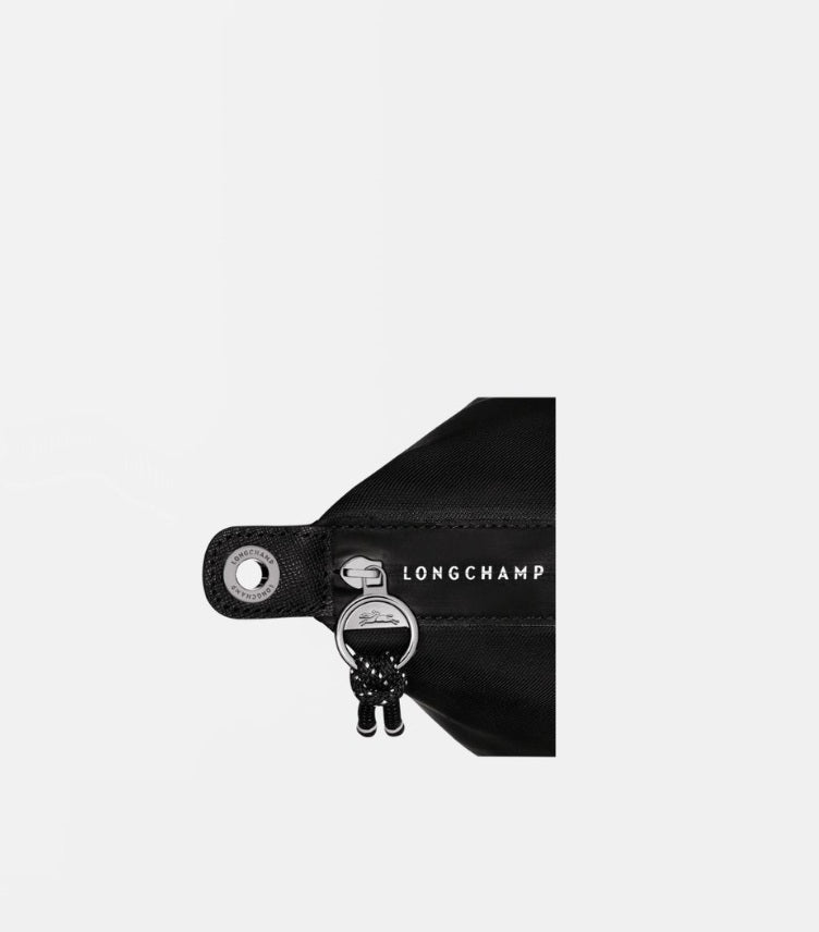 Close-up of Longchamp Le Pliage Energy Large handbag zip closure, branded trim and rope-style zip pull