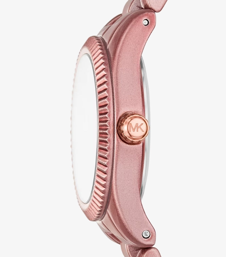 Close-up side view of Michael Kors limited-edition pink-tone watch with fluted bezel and rose gold MK crown