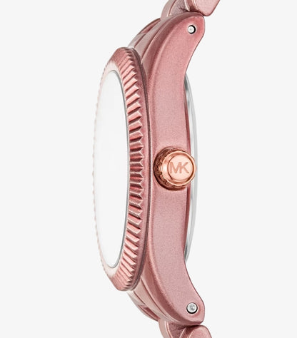 Close-up side view of Michael Kors limited-edition pink-tone watch with fluted bezel and rose gold MK crown