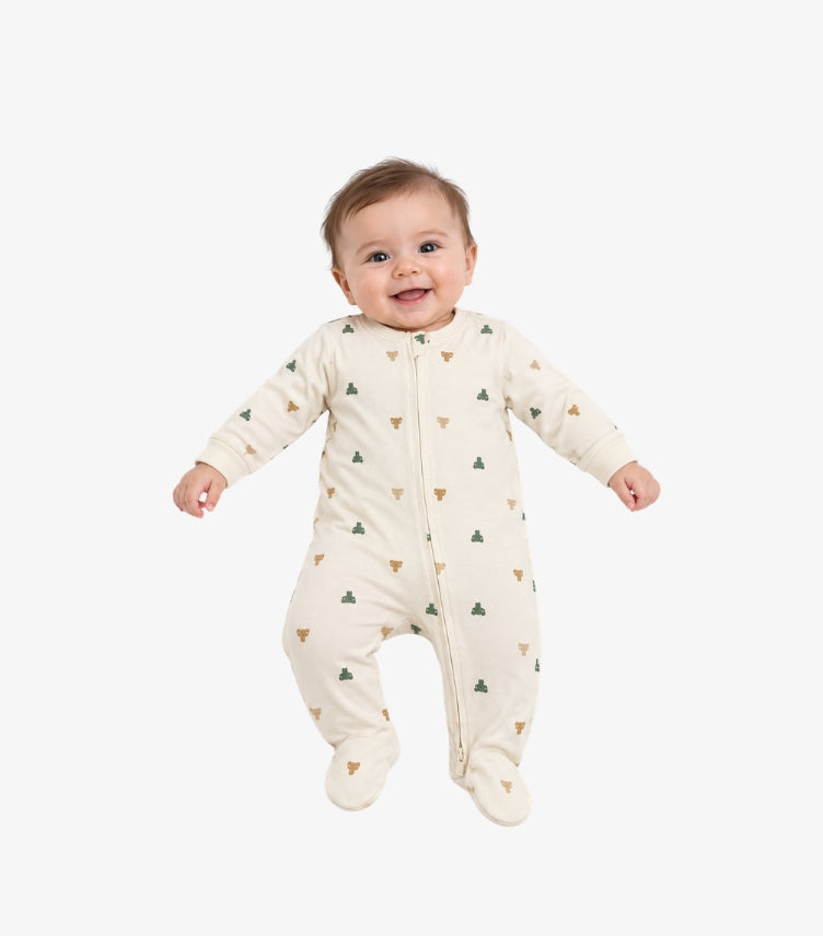 Baby wearing a cream GAP footed sleepsuit with long sleeves, front zip and green and brown bear print