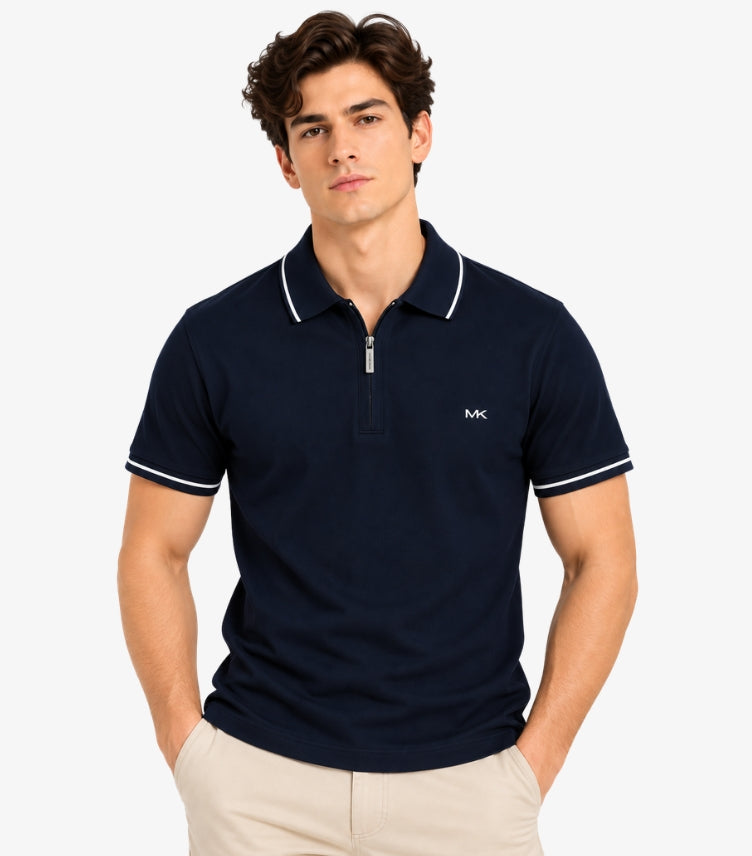 Man wearing a Michael Kors navy short-sleeve polo shirt with a quarter-zip neckline, white piping and MK chest logo