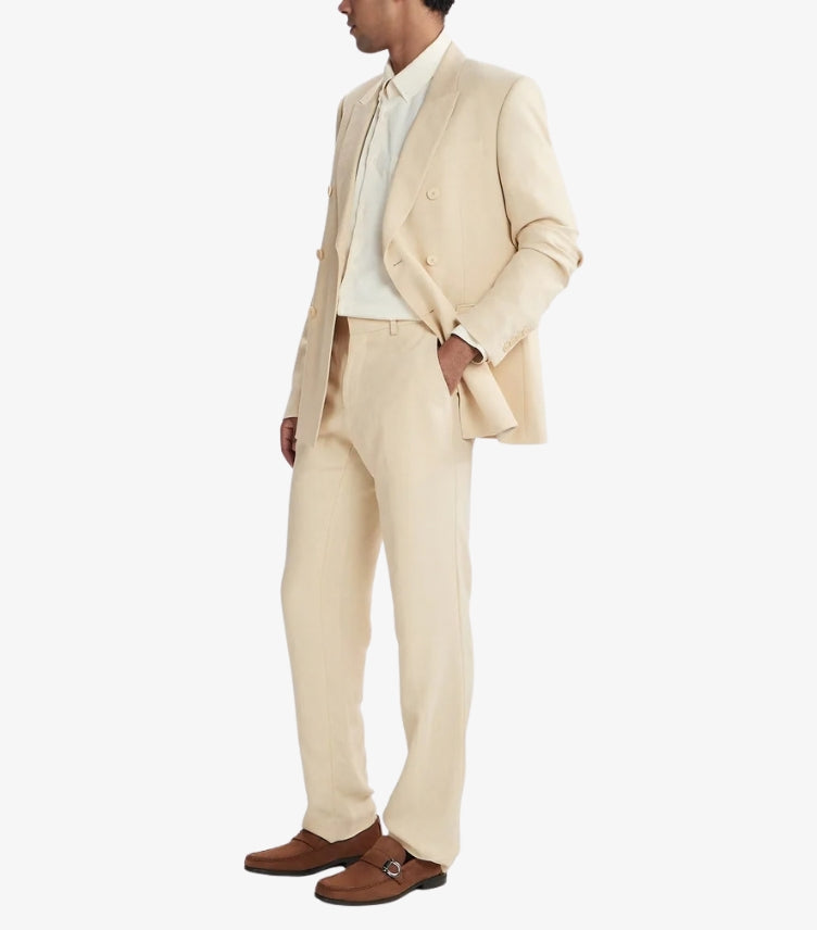 Man wearing Ferragamo brown suede Gancini loafers with a cream tailored suit