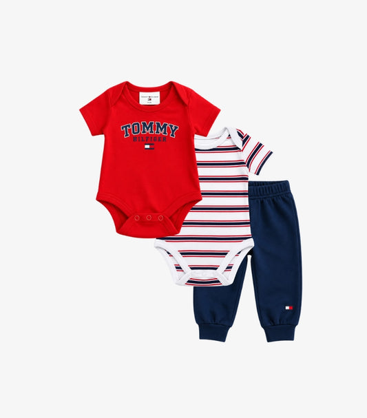 Tommy Hilfiger baby boys 3-piece outfit set featuring a red logo bodysuit, white striped short-sleeve bodysuit and navy blue joggers.