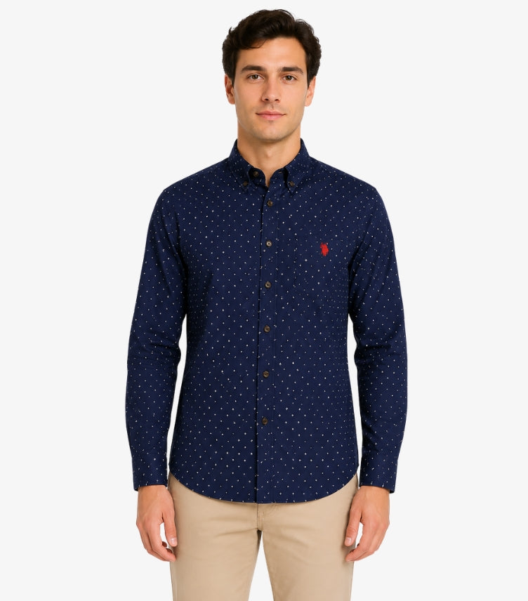 Male model wearing a U.S. Polo Assn. men’s navy blue micro-print long-sleeve shirt with button-down collar and embroidered red logo