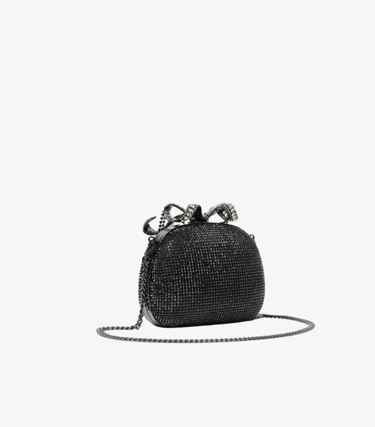 Black crystal embellished mini bag angled view showing gunmetal chain crossbody strap and crystal bow