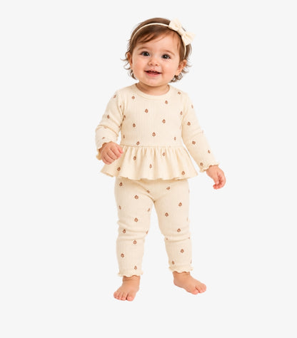 Carter's baby girl wearing a cream floral print long-sleeve peplum top with matching ribbed leggings and delicate ruffle details.