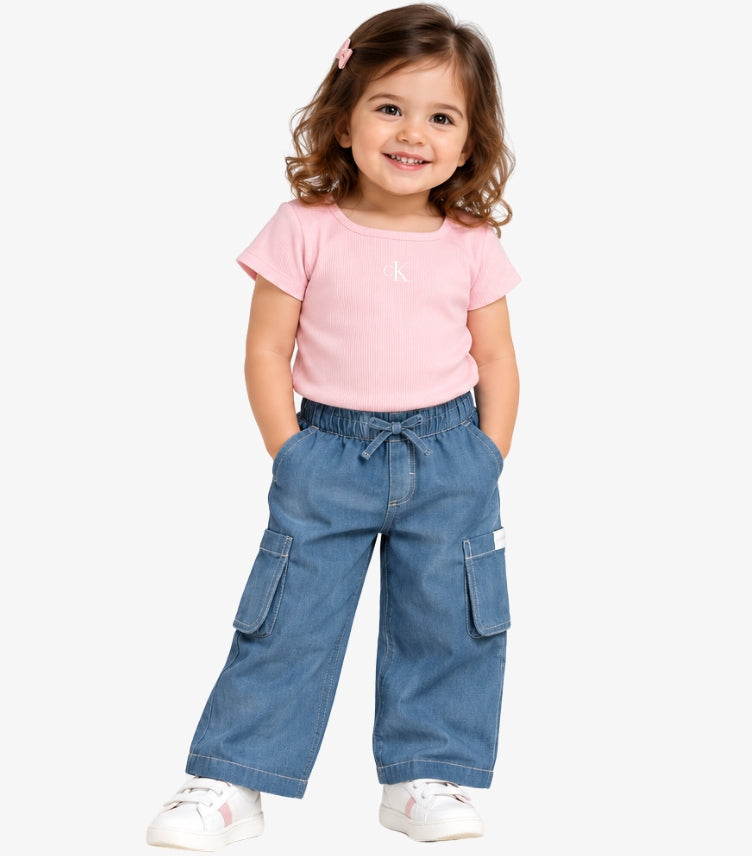 Girl wearing a Calvin Klein pink ribbed logo T-shirt with blue drawstring cargo trousers and white trainers