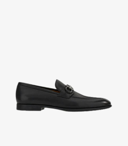Ferragamo Gancini Bit loafer black leather side profile showing low stacked heel and slip-on silhouette