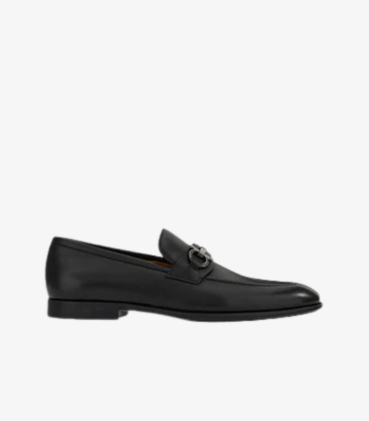 Ferragamo Gancini Bit loafer black leather side profile showing low stacked heel and slip-on silhouette