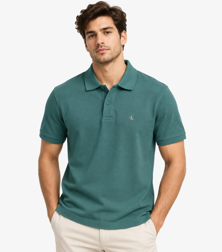 Model wearing a green Calvin Klein short-sleeve polo shirt with embroidered CK chest logo
