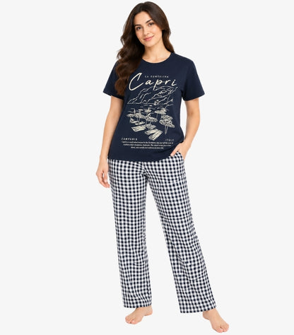 Front view of a model wearing a Marks & Spencer Capri graphic T-shirt pyjama set with check-pattern bottoms and side pockets