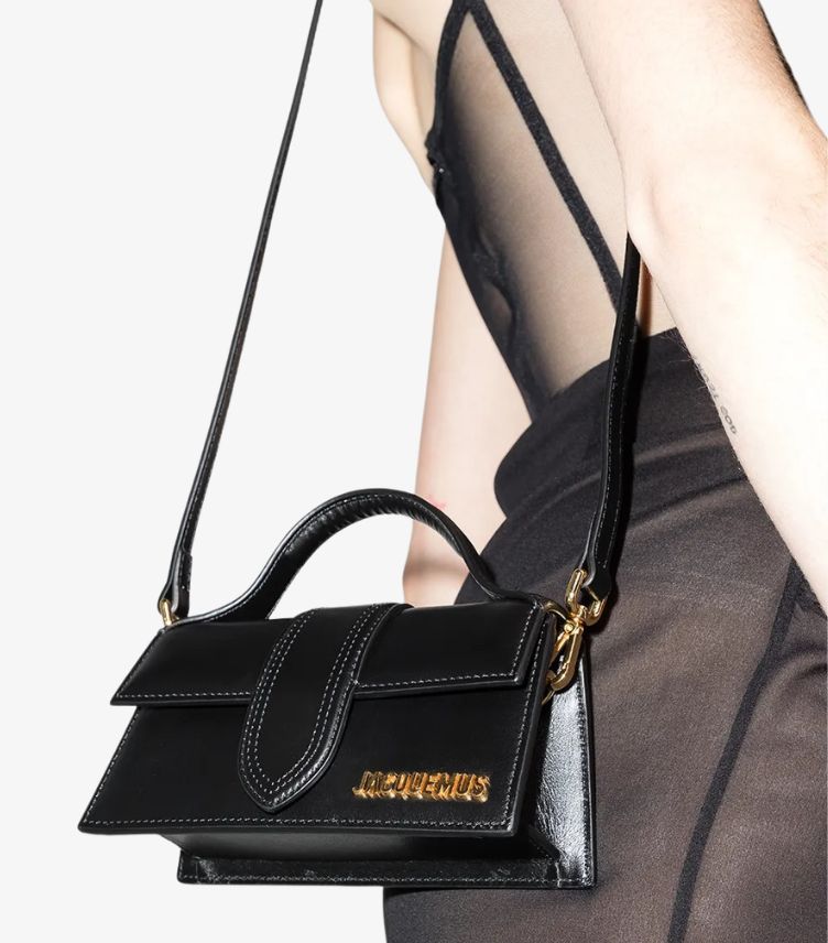 Model wearing Jacquemus black leather mini bag with adjustable shoulder strap