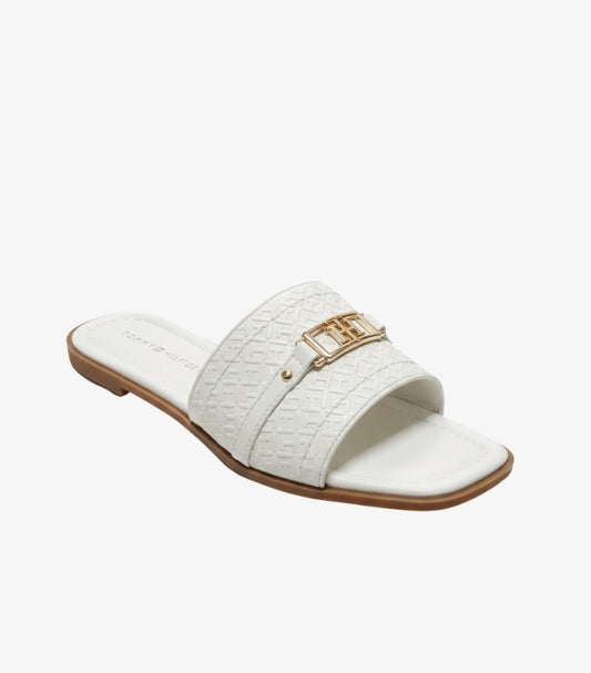 TOMMY HILFIGER WOMEN’S EMBOSSED MONOGRAM SLIDES