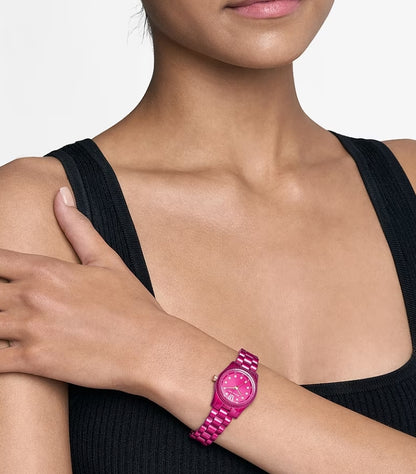 Woman wearing a Michael Kors petite pink-tone stainless-steel watch with pavé indexes and rose gold details