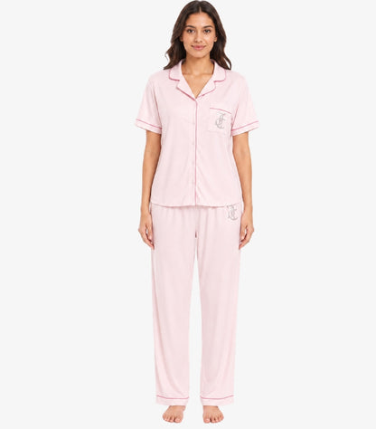 Front view of model wearing Juicy Couture women’s light pink short-sleeve pajama set with rhinestone JC logos