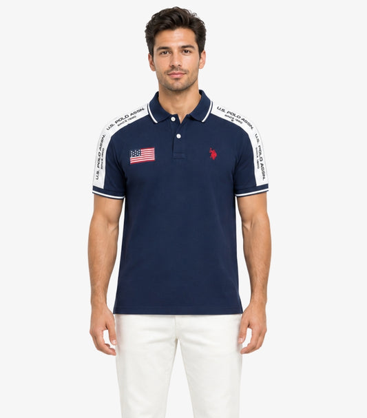 U.S. Polo Assn. men's navy short sleeve cotton polo shirt featuring embroidered logo, American flag patch, and branded contrast shoulder tape.