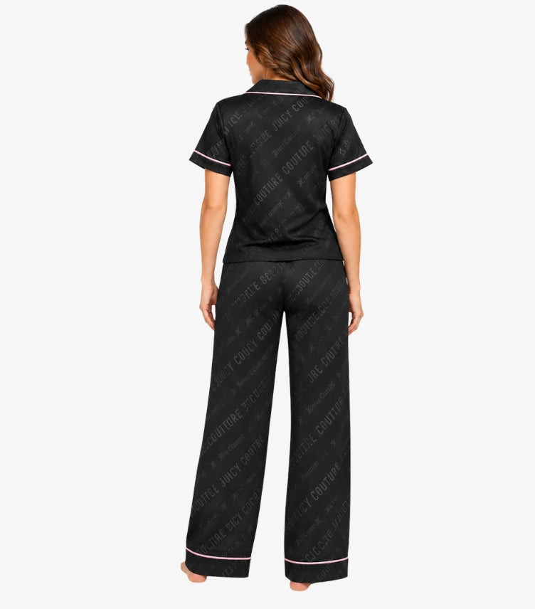 Back view of Juicy Couture women’s black satin-effect pyjama set with tonal logo pattern and pink piping