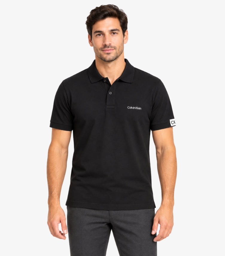 Calvin Klein Men's Black Polo Shirt featuring short sleeves, classic button collar, signature chest logo and CK sleeve detail.