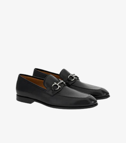 Ferragamo men's black leather Gancini Bit loafers angled view showing silver hardware and apron toe stitching